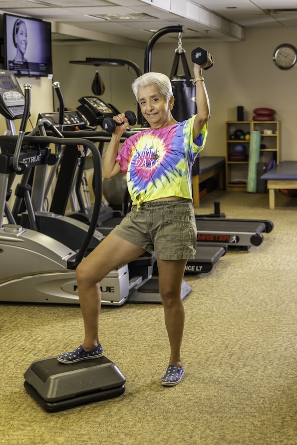 Marti holding weights in the gym